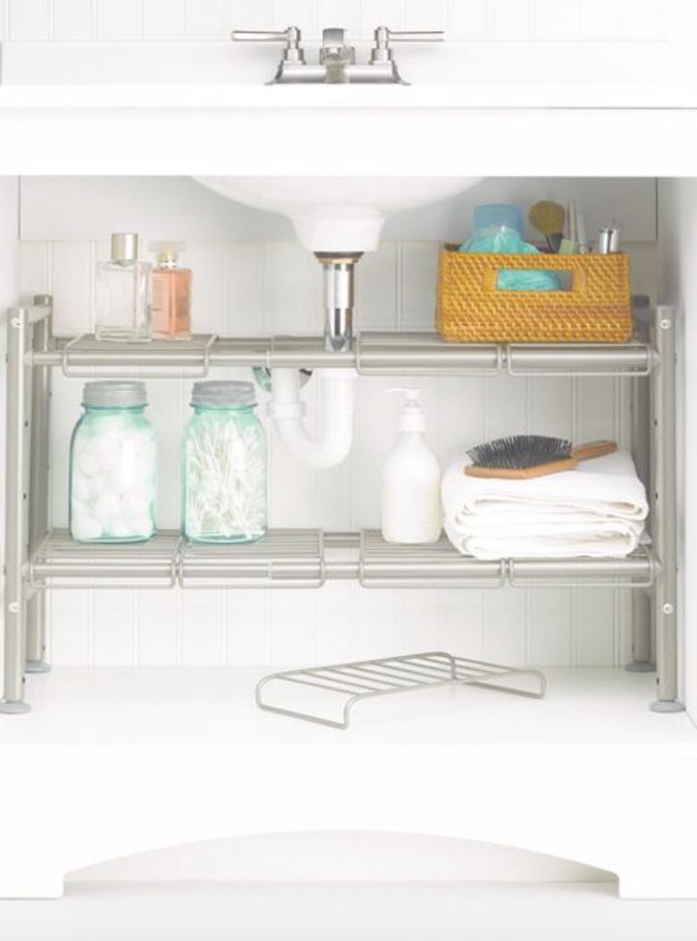 Two adjustable metal shelves underneath sink.