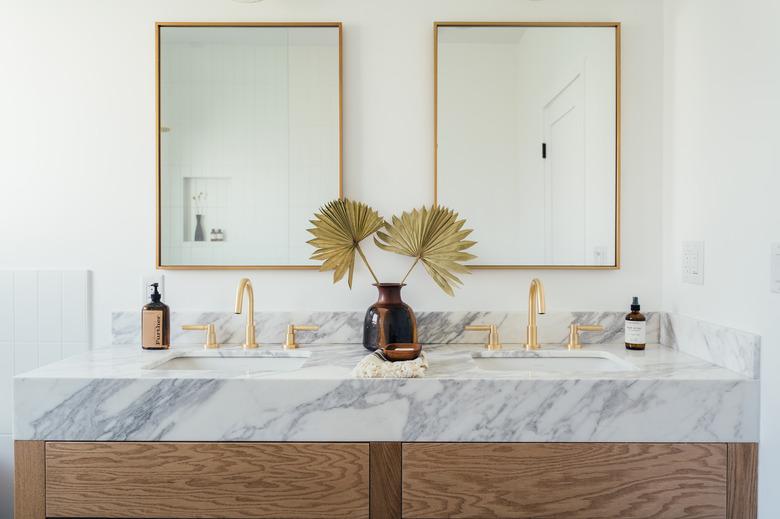 coastal bathroom with marble countertop and double sinks