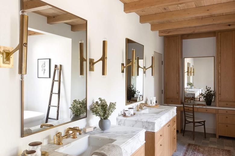 farmhouse bathroom with exposed wood beams at ceiling and stone flooring