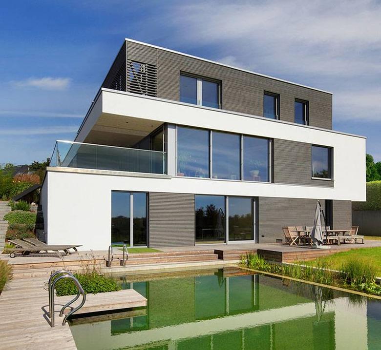 Bauhaus house with pool in backyard and outdoor furniture