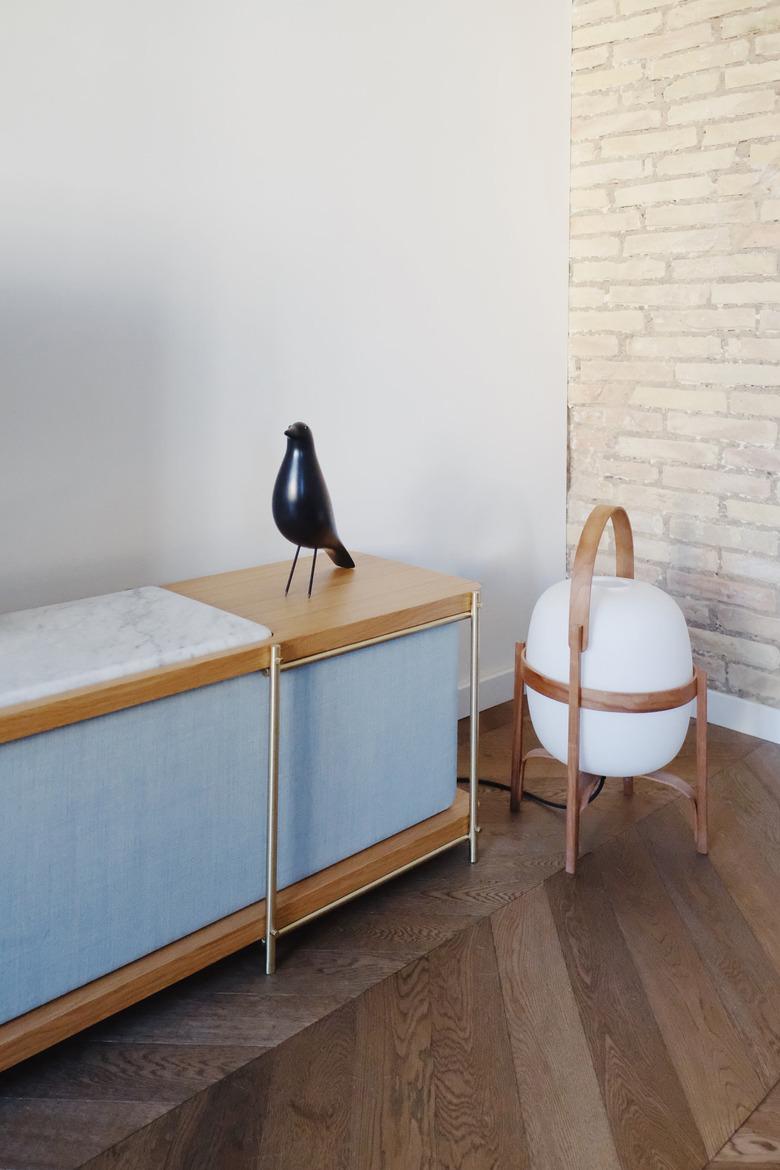 Bauhaus style room with modern sideboard, lantern, and bird sculpture