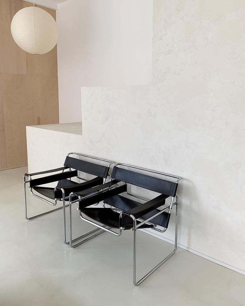 Bauhaus style room with two vintage Bauhaus chairs in black and hanging paper lantern