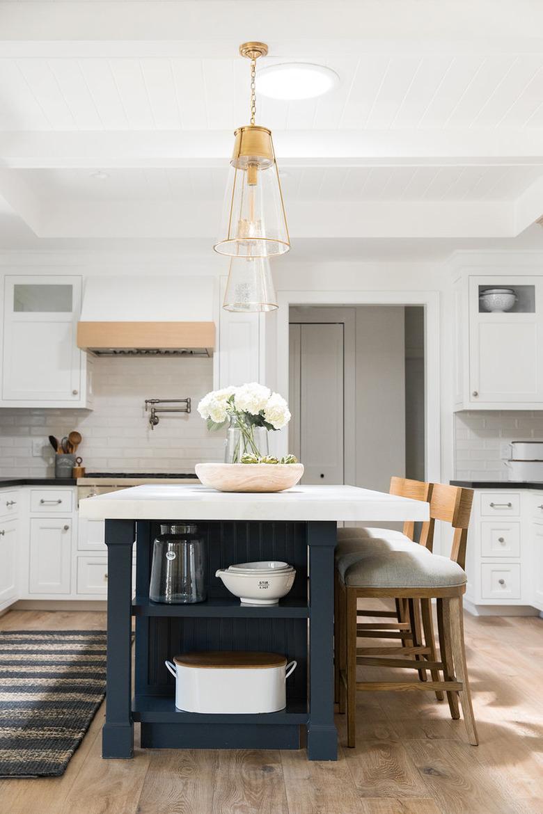 dark blue beadboard kitchen island with white countertop