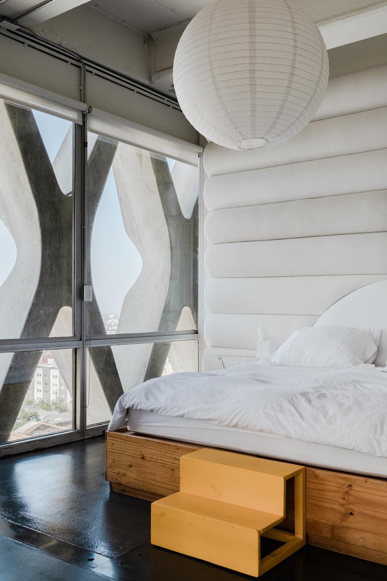 Loft bedroom with white fabric walls