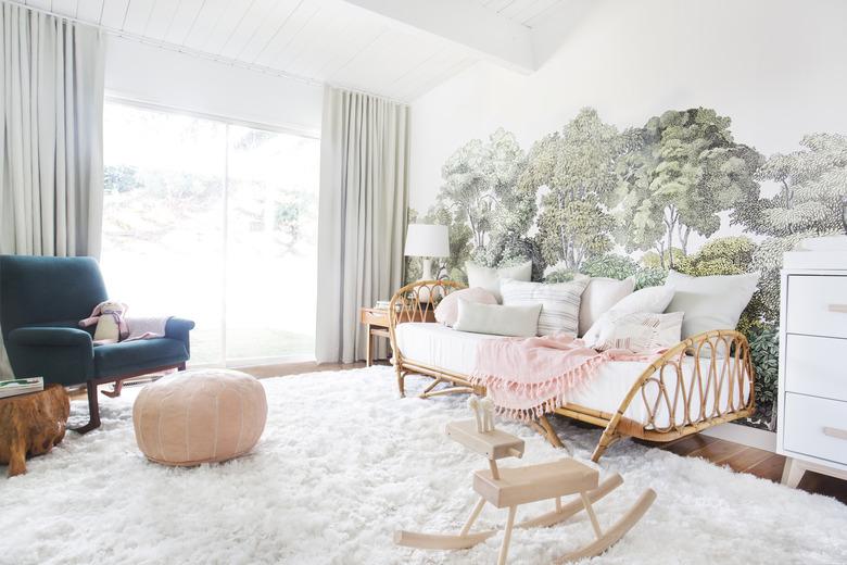 girls bedroom idea with rattan daybed and tree mural