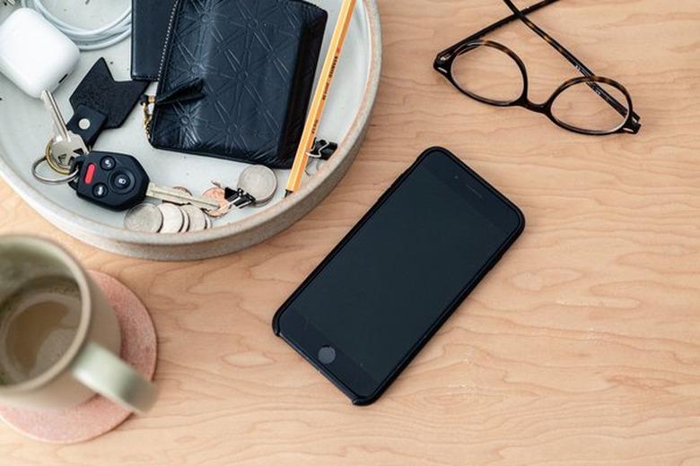 Cell phone sitting on wood table