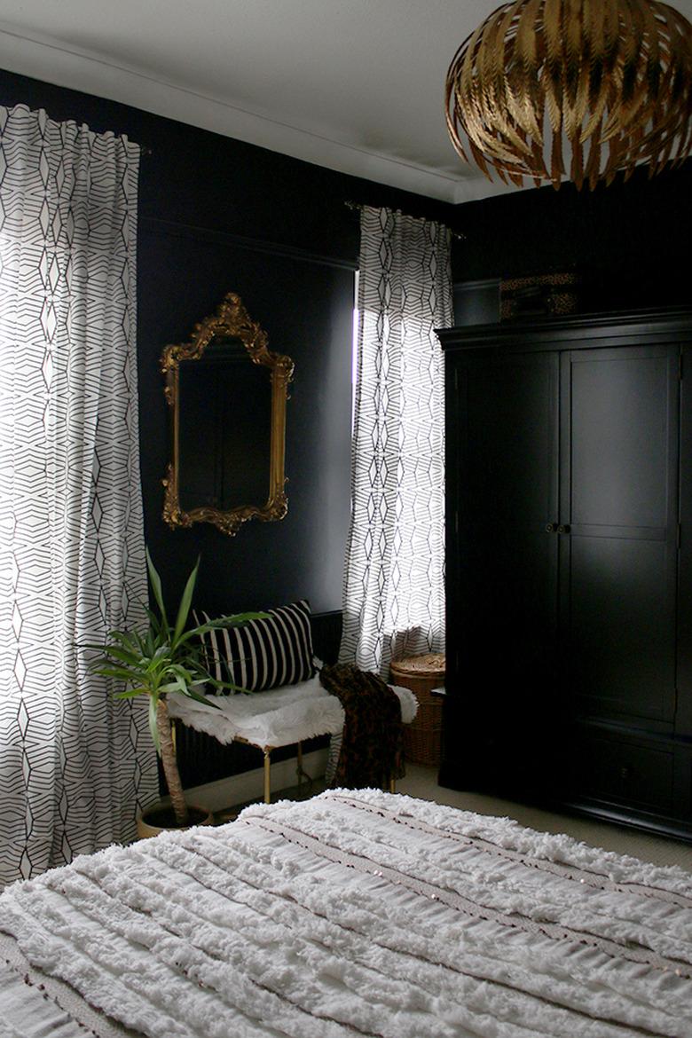 black bedroom with white and gold luxe accents