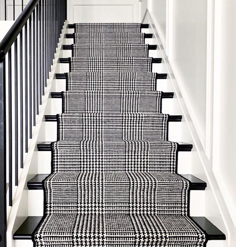 black and white stairs with houndstooth runner