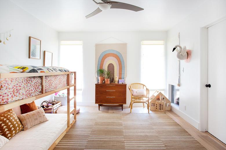 neutral bohemian kids bedroom idea with rainbow wall hanging