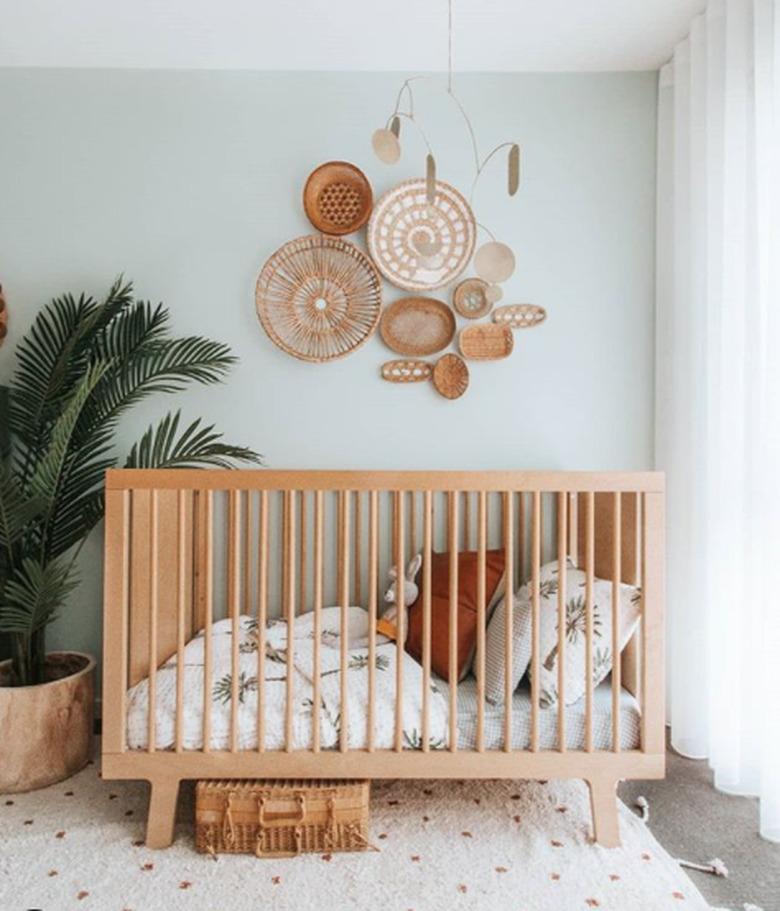 bohemian baby nursery idea with mint green walls with basket art