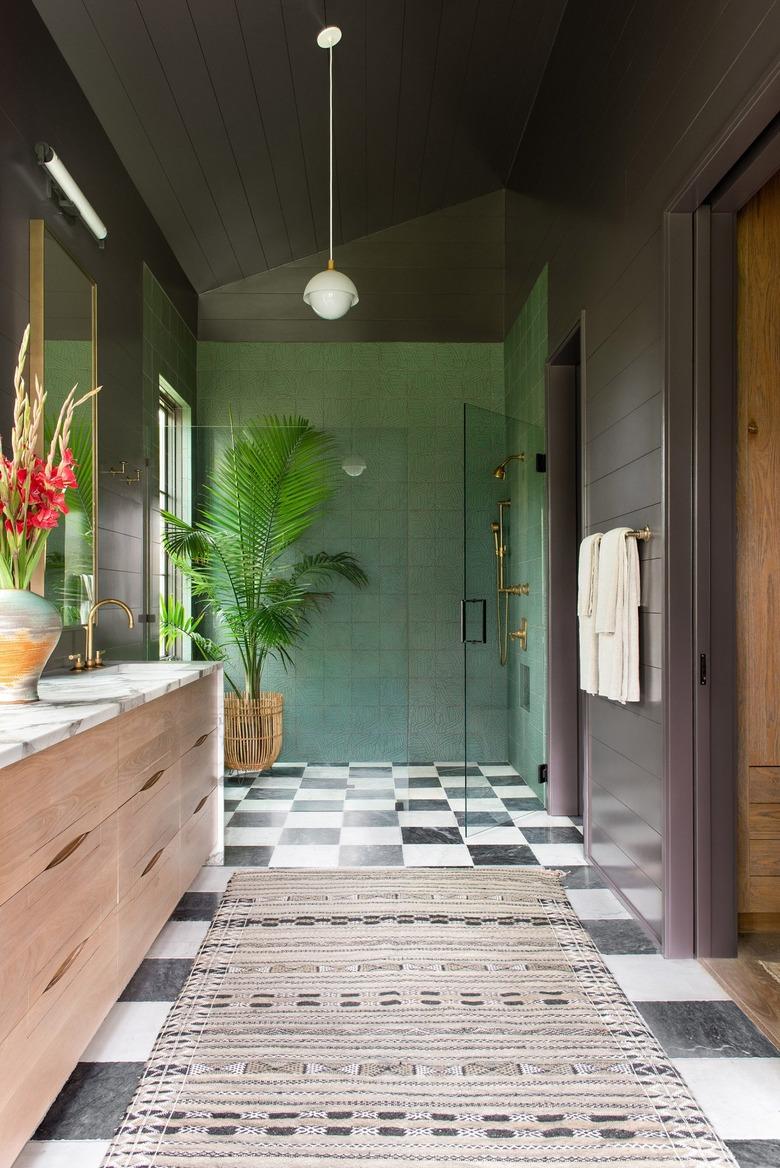 sophisticated dark bathroom with gray walls and green tiled bohemian shower