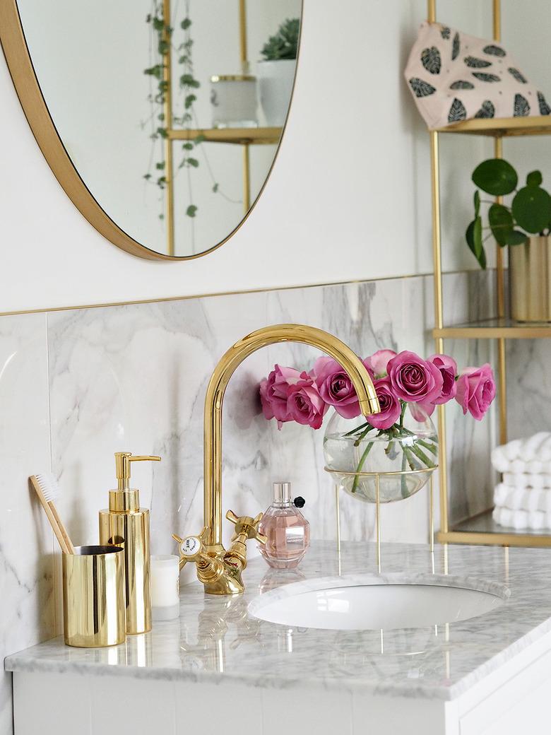 Brass Bathroom Faucet in luxury marble bathroom with brass faucet and decor