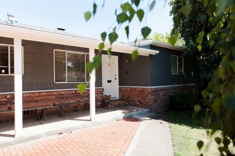 ranch house facade, brick and concrete patio