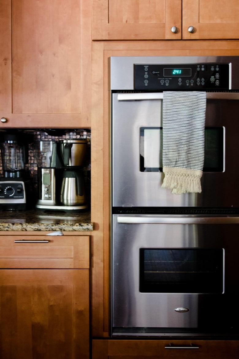 Kitchen with wood cabinets, stainless steel double oven.