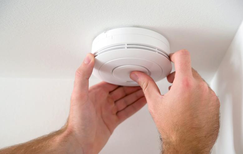 Man installing smoke detector