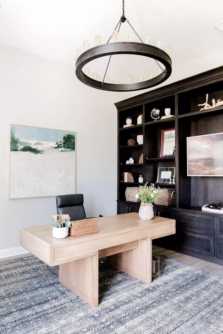 black circular candelabra chandelier in transitional style office