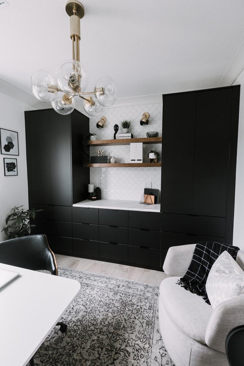 brass midcentury chandelier in black and white modern office