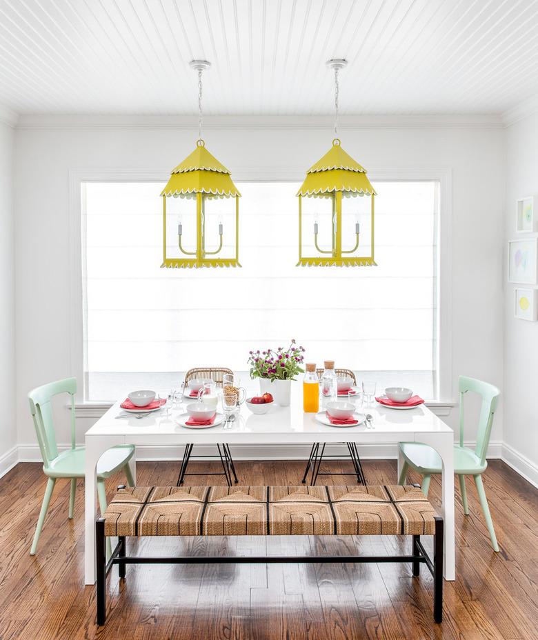 chartreuse color idea in white dining room with chartreuse pendants over table