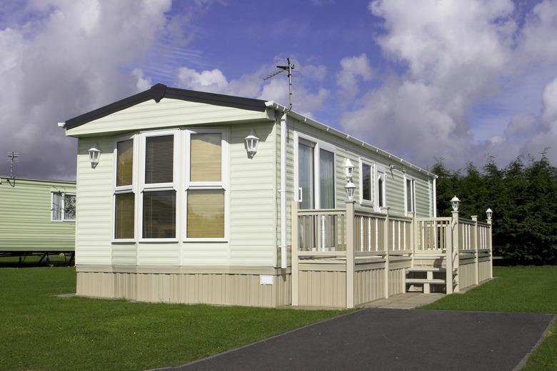 Stationary Mobile home with vinyl skirting.