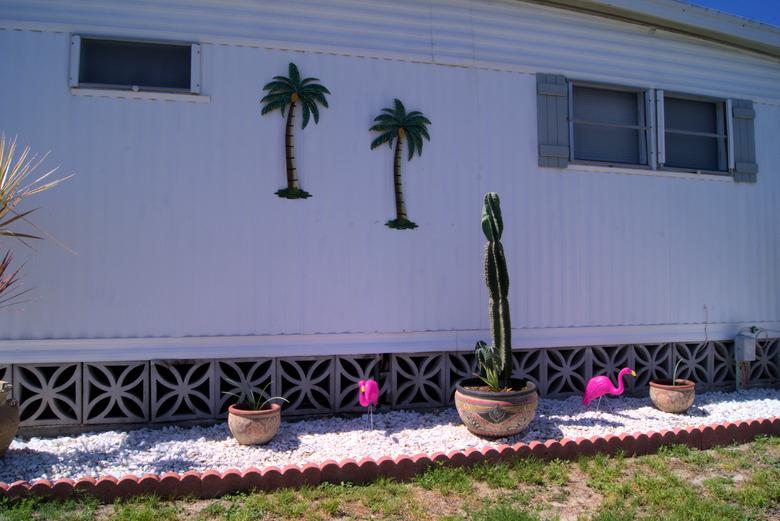 Mobile home back yard with decorative block skirting.