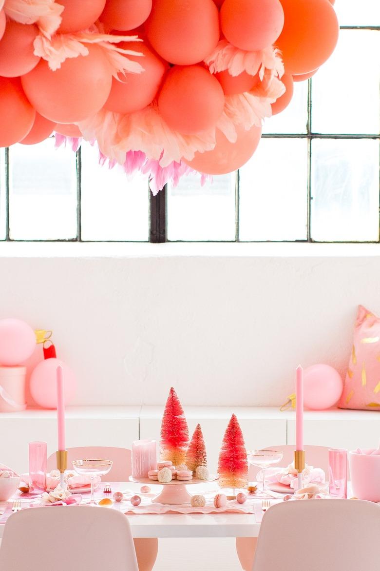 pink dining room with balloons and bottlebrush trees for Christmas centerpiece