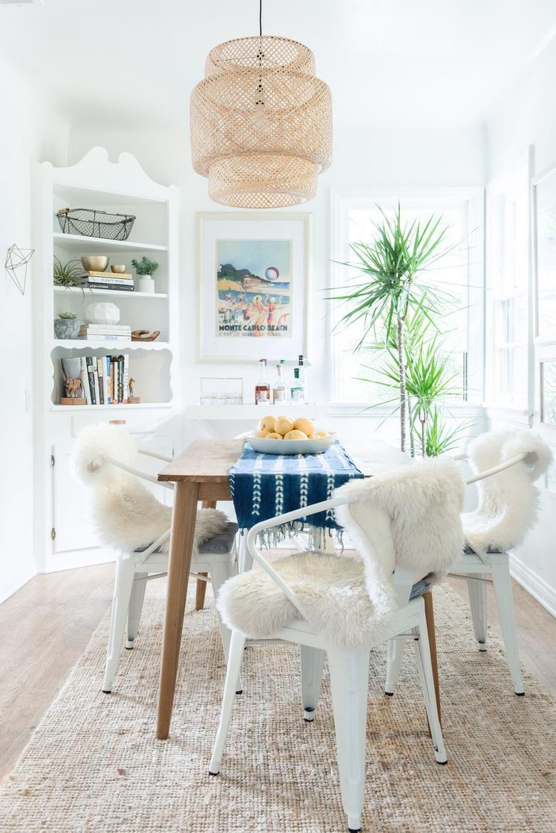 small coastal dining room with ikea pendant and jute rug