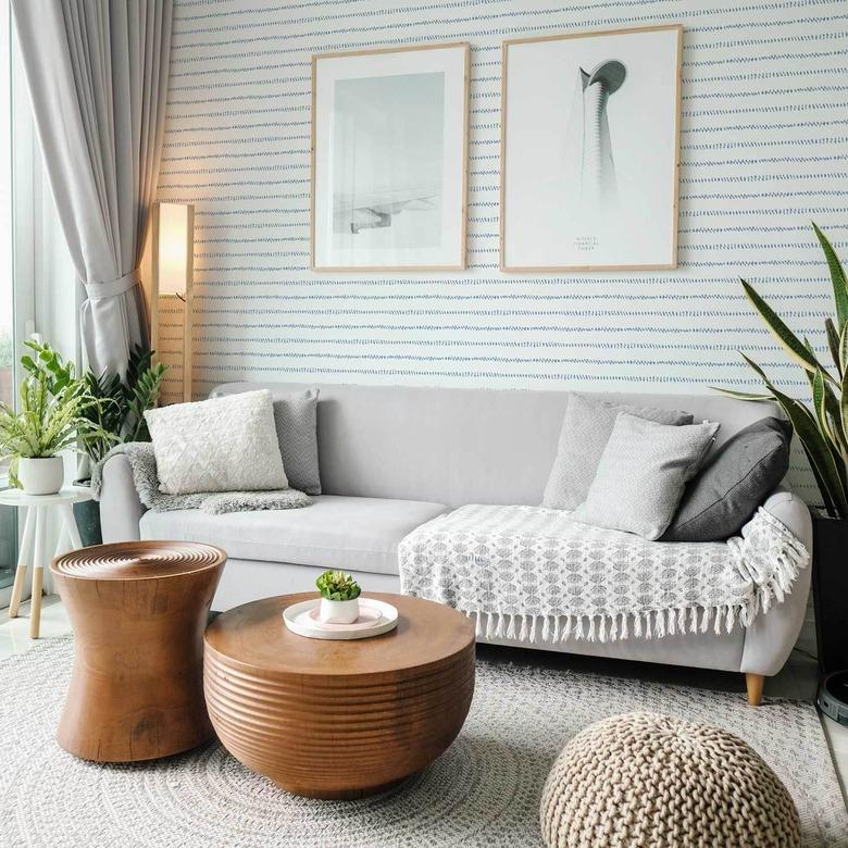 cosy coastal living room with watercolor blue stripes coastal wallpaper