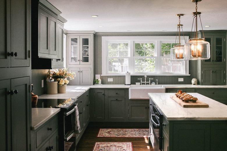 Kitchen with gray cabinets and walls with white molding