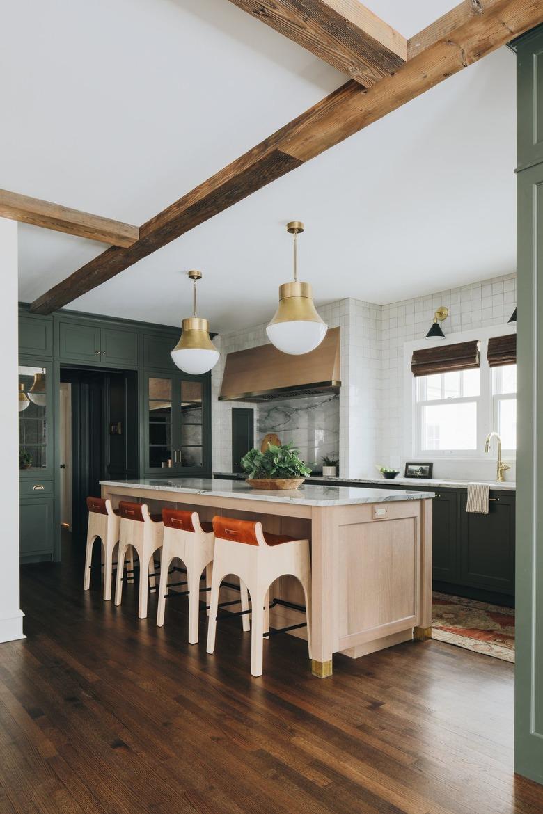 Kitchen with green cabinets and wood beams