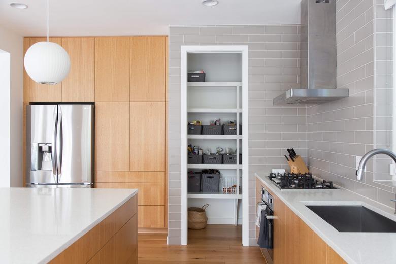 honey oak cabinets and gray backsplash tile