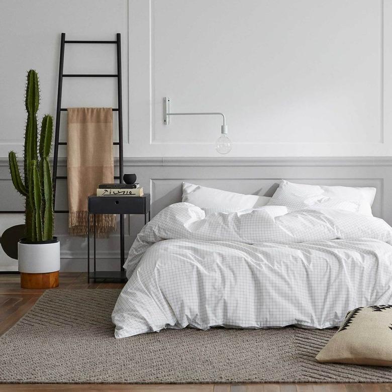 cozy bedroom with white bedding and minimalist decor