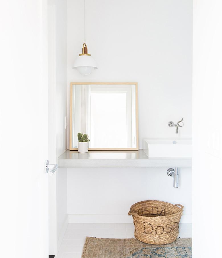 all white minimalist bathroom with concrete countertop