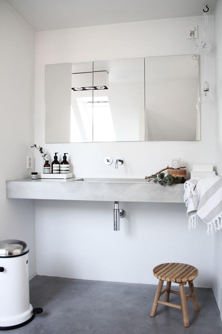 bathroom with floating concrete countertop