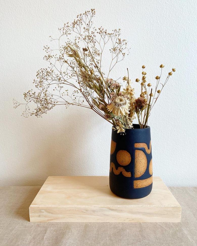 black contemporary ceramics vase with shapes in brown