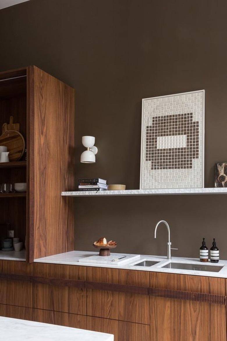 contemporary kitchen with wood cabinets and brown walls