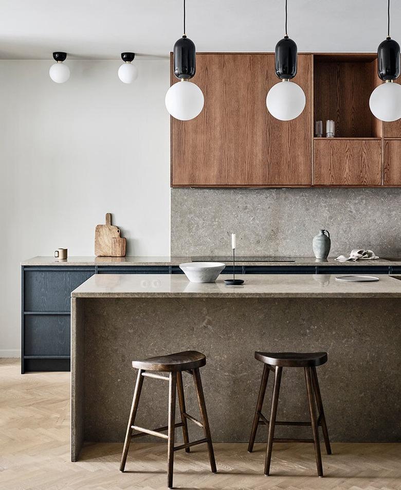 contemporary kitchen with painted and wood cabinets and limestone countertops