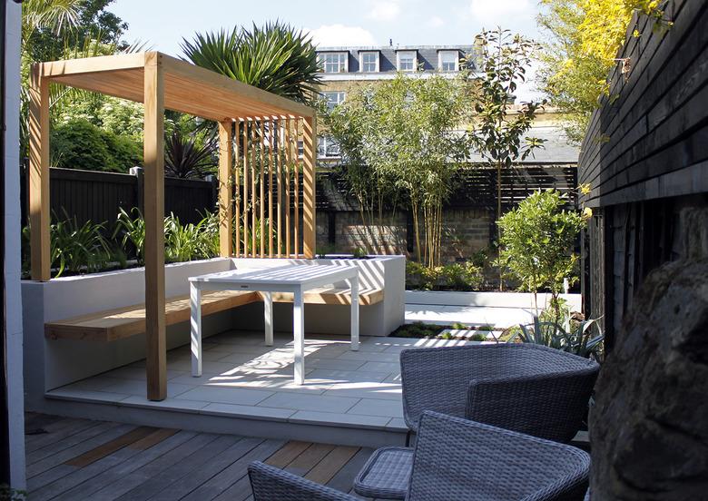 Downsized wood contemporary pergola on deck next to palm trees