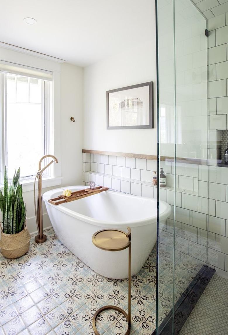 white bathtub on tiled floor