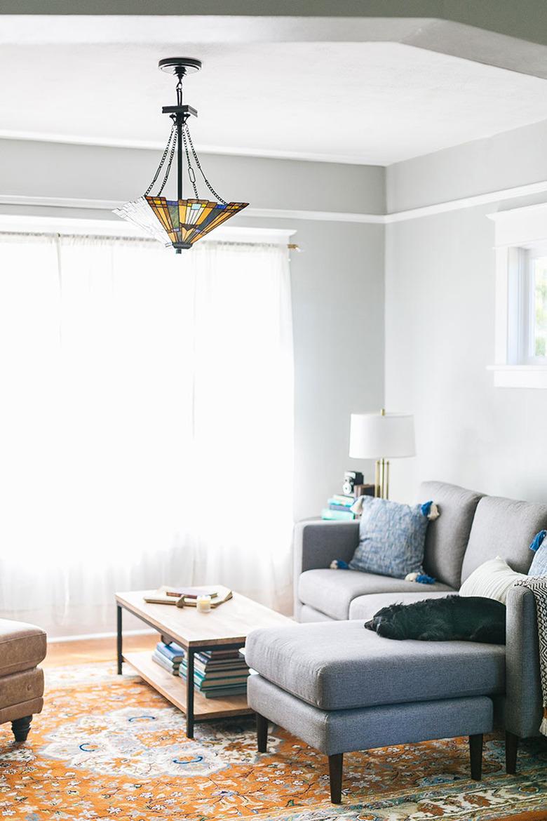 Craftsman living room with modern sofa and Tiffany ceiling light