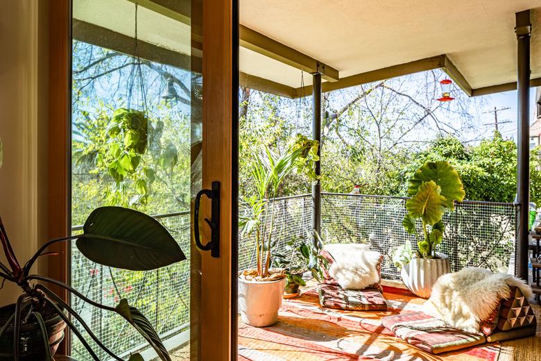 Boho chic balcony with seating area and hanging plants