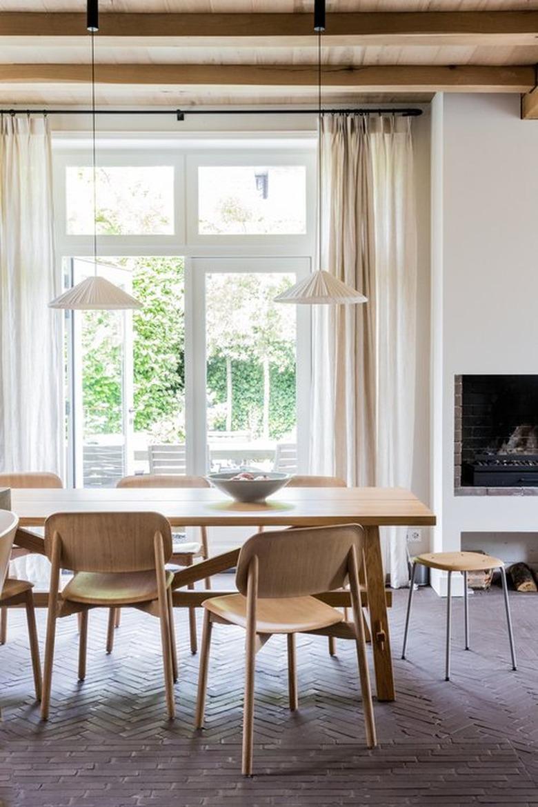 dining room with beige walls and cream curtains