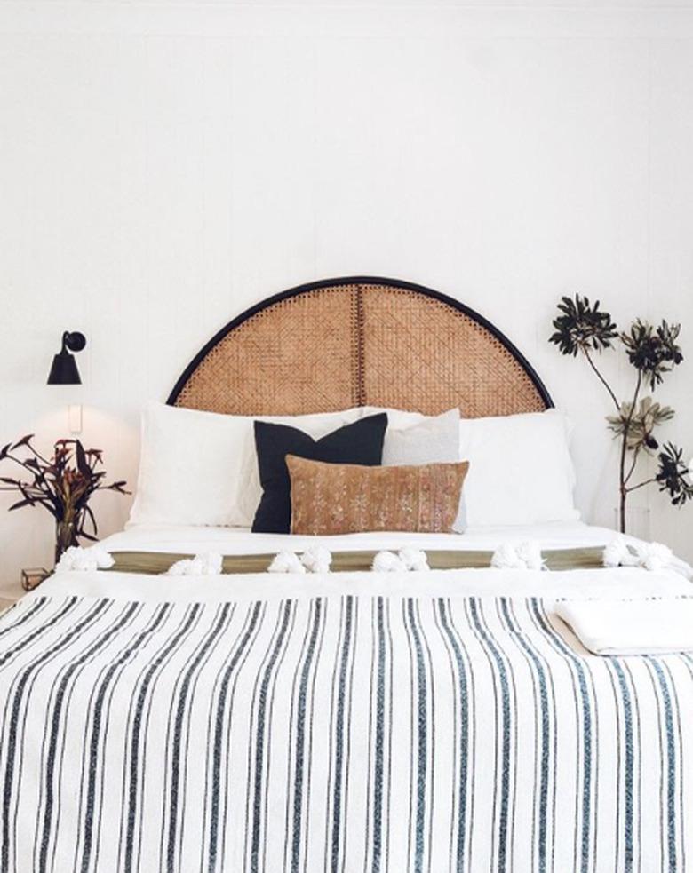 desert themed bedroom with curved rattan bed