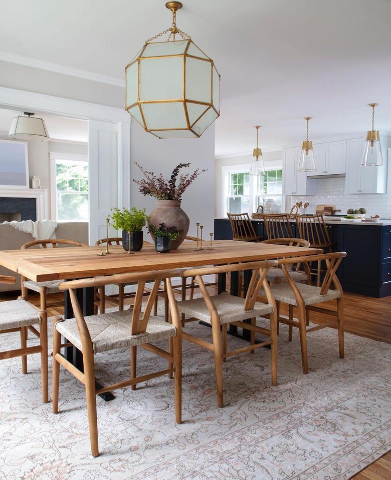 dining room table centerpiece with wishbone chairs gold oversize dining room light in casual dining room