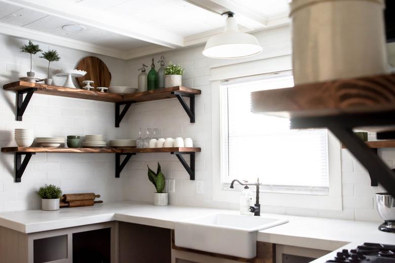 Kitchen with white concrete countertop and open wood shelving