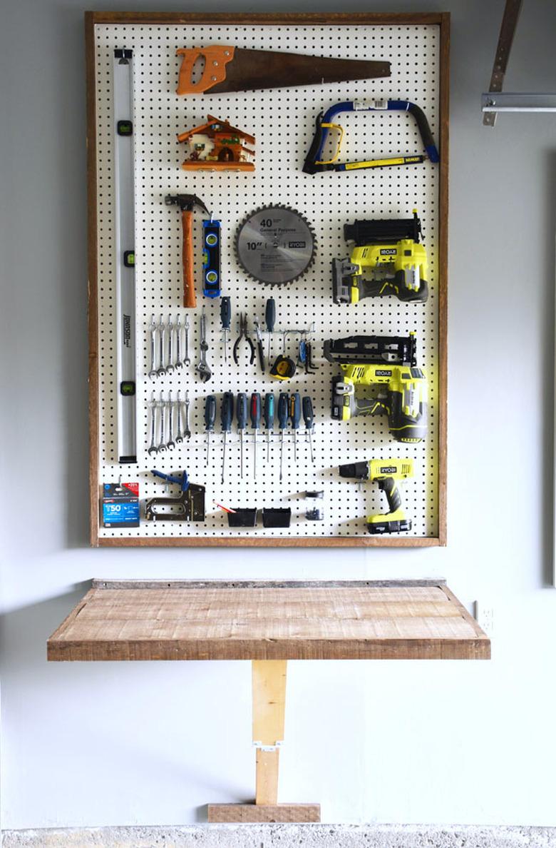 DIY garage organization idea with pegboard with power tools above a work bench