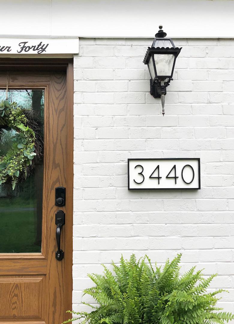 DIY house number sign with white background and black numbers