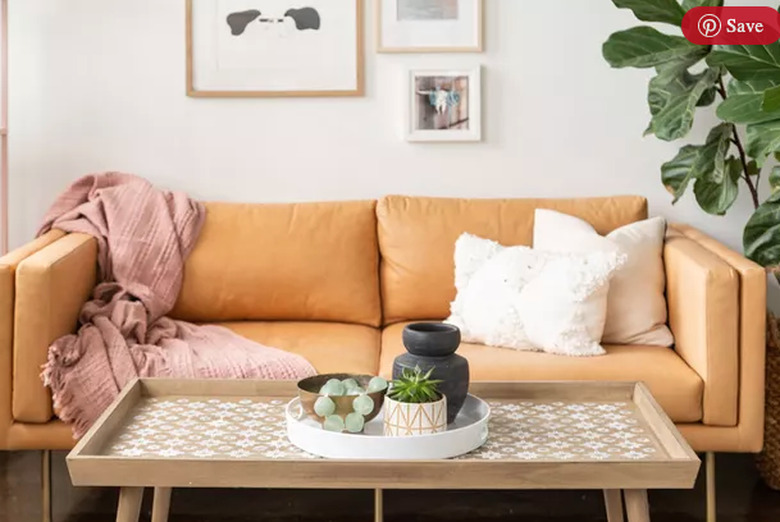 Stenciled coffee table and tan leather couch