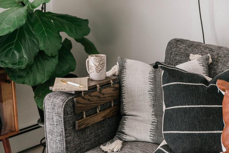 diy rustic decor wood tabletop with mug and calendar on gray sofa with pillows next to plant