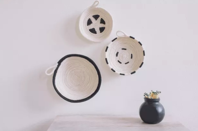 Painted black and white rope bowls hung on wall