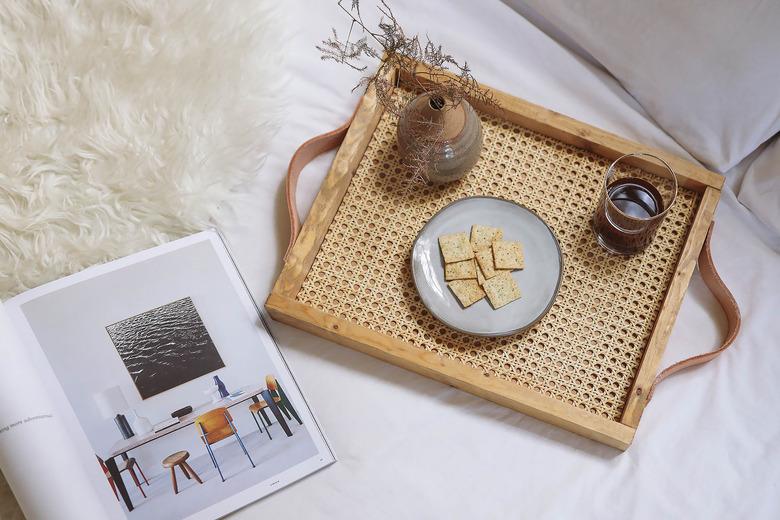 Cane and leather tray on bed